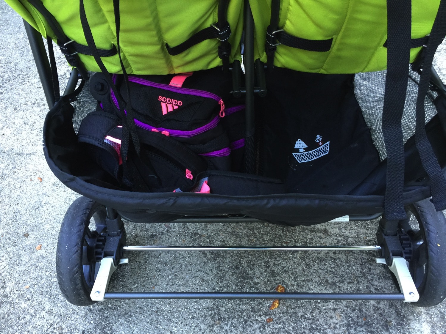 Giant backpack in basket of joovy scooter x2 with room to spare