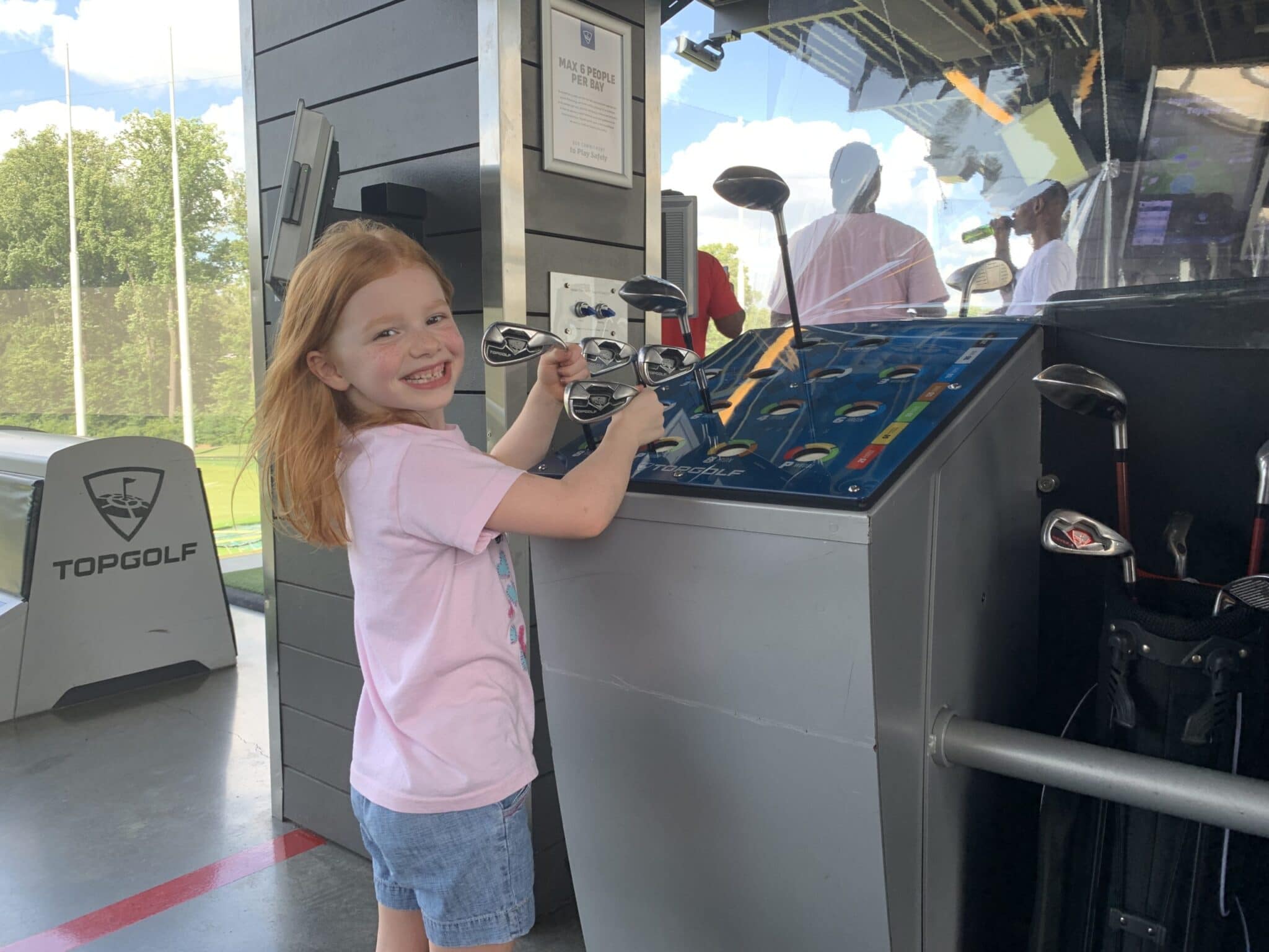 selecting a golf club at topgolf